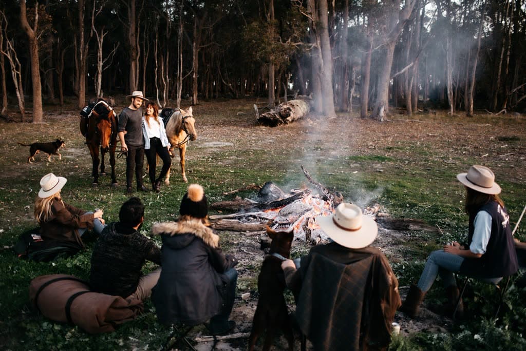 Gathered around the campfire by the treehouse at dusk, Jesters Flat