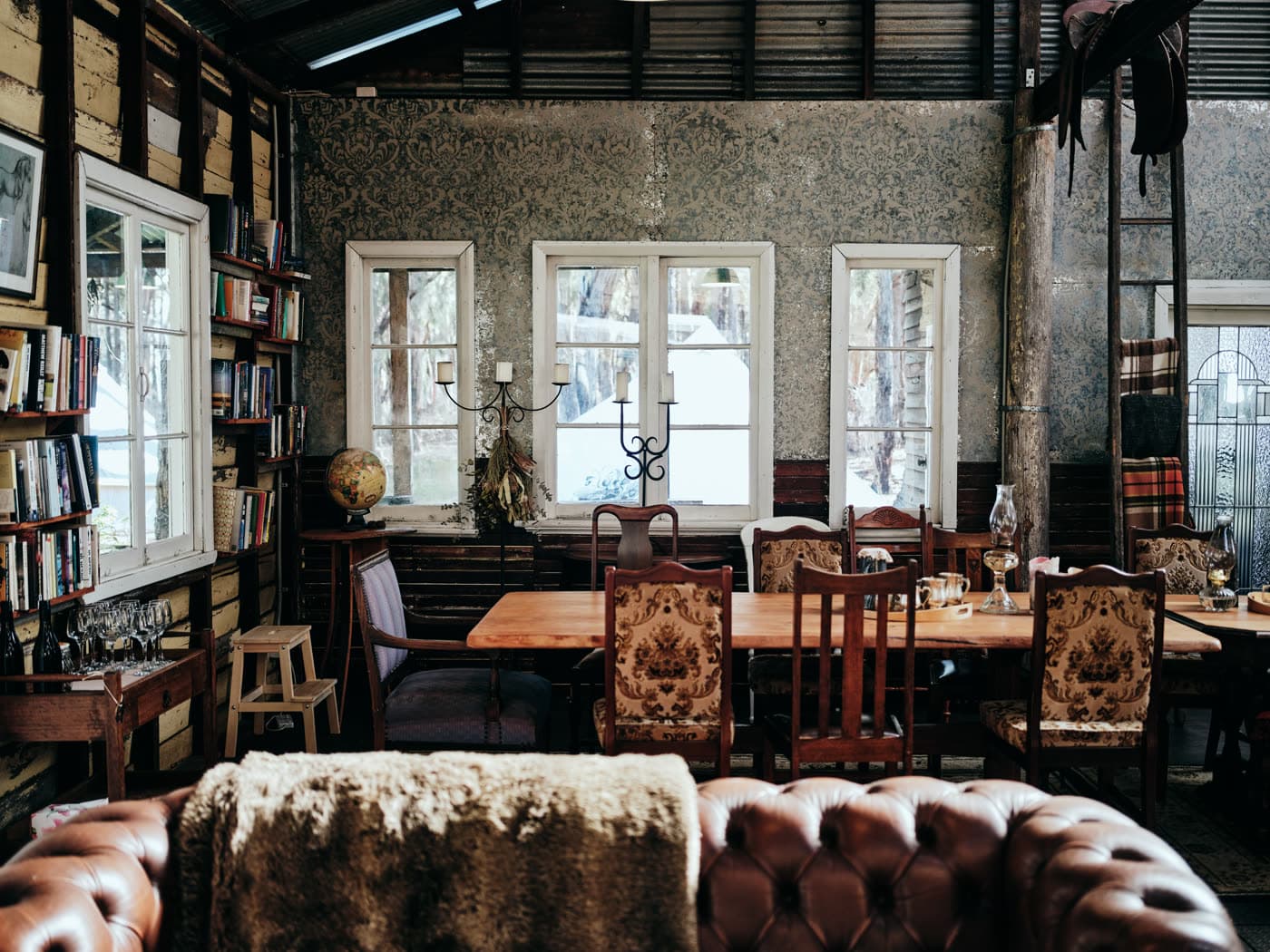 The clubhouse dining room with books and vintage furniture, Jesters Flat